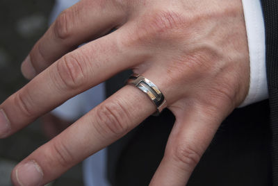 Cropped image of hand holding wood