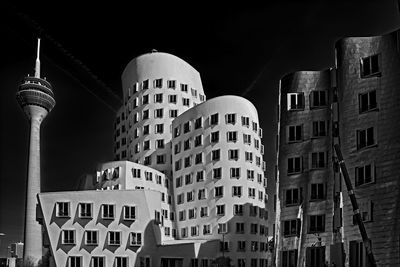 Low angle view of buildings in city at night