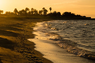 Scenic view of beach against sky during sunset