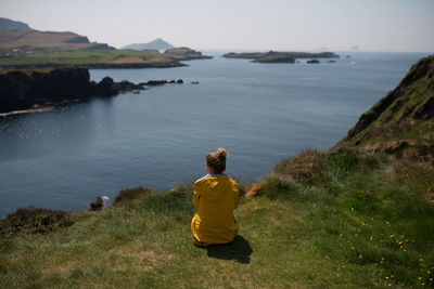 Rear view of a woman overlooking sea