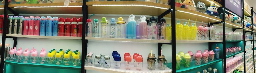 Multi colored bottles in shelf at store