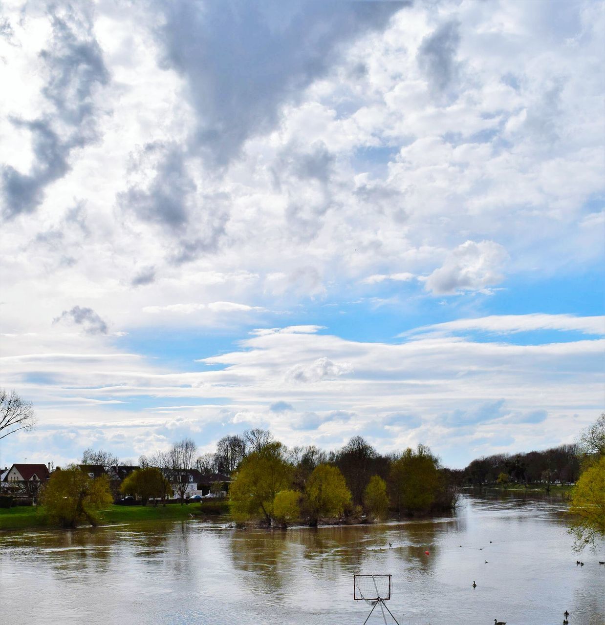 water, tranquil scene, lake, tranquility, waterfront, reflection, tree, sky, calm, scenics, cloud, beauty in nature, nature, river, cloud - sky, non-urban scene, standing water, majestic, day, countryside, outdoors, cloudy, no people