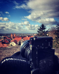 Surface level of camera against trees and sky