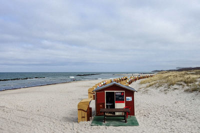 Lifeguard hut on beach against sky