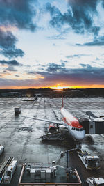 High angle view of airport runway against sky during sunset