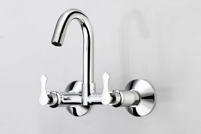Close-up of faucet against white background