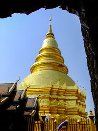 Low angle view of pagoda against clear blue sky