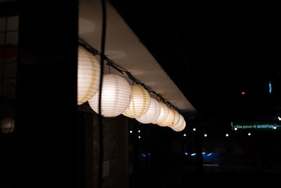 Low angle view of illuminated pendant lights
