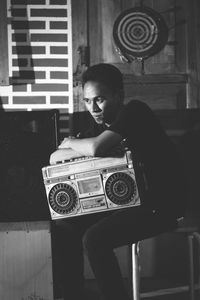 Young man with radio sitting at home