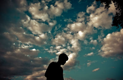 Silhouette man against cloudy sky