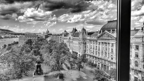 View of cityscape against cloudy sky