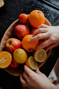 Cropped image of hand holding fruits