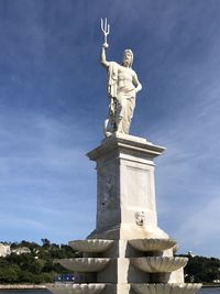 Low angle view of statue against sky