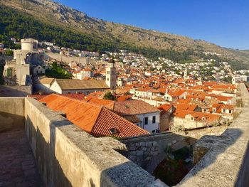 High angle view of houses in town against clear sky