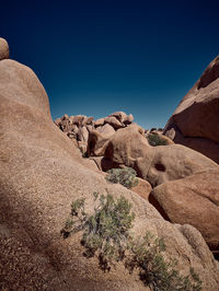 Rock formations against clear blue sky