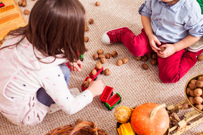 High angle view of girl sitting on table