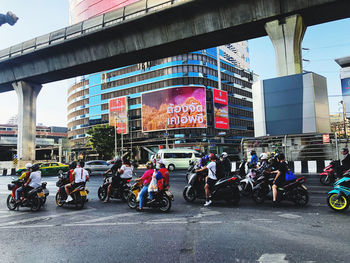 People on road with bridge in background