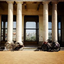 Bicycle parked against building