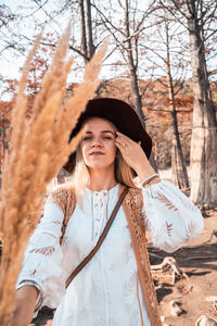Young woman wearing hat while standing on land