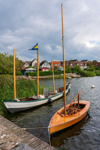 Boats moored at harbor