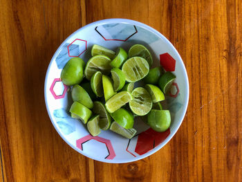 High angle view of chopped fruits in bowl on table