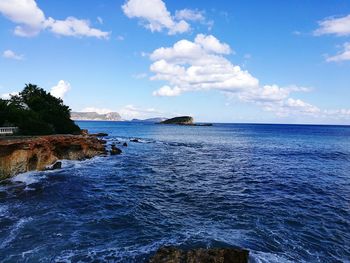 Scenic view of sea against blue sky