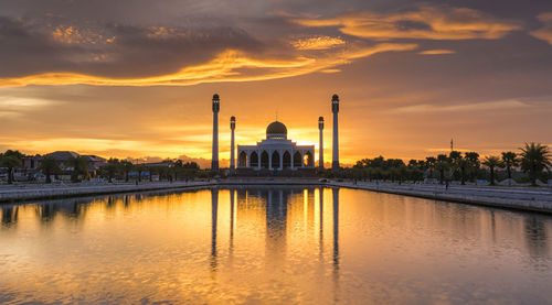 Scenic view of illuminated building against sky during sunset