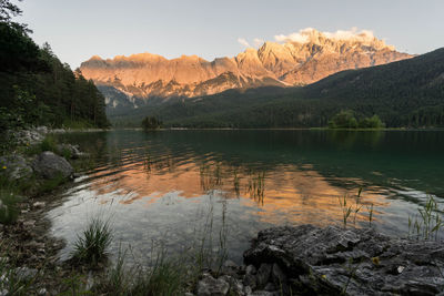 Scenic view of lake and mountains against sky