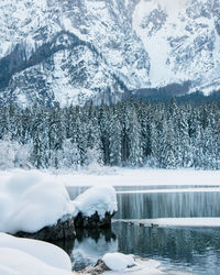 Frozen lake by snowcapped mountain during winter