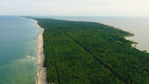 High angle view of land and sea against sky