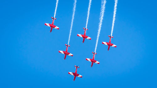 Low angle view of airshow against sky