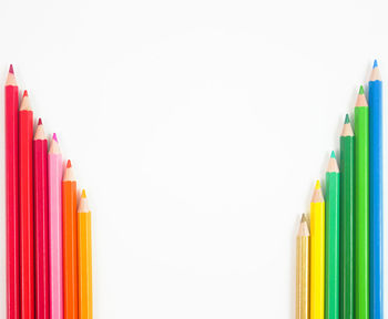 Close-up of colored pencils against white background