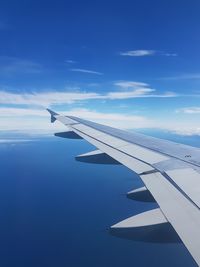 Close-up of airplane wing against sky