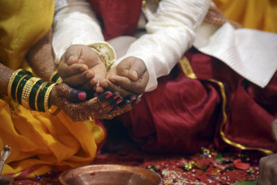 Midsection of couple at wedding ceremony