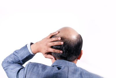 Rear view of boy against white background