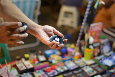 Cropped hands holding dice at market