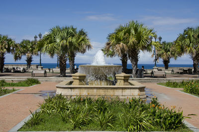 Fountain in park against blue sky