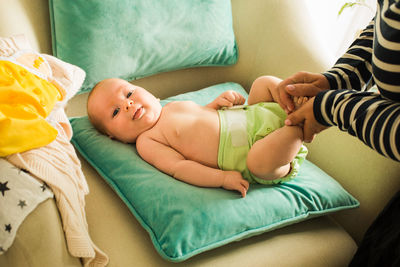 High angle view of baby sleeping on bed