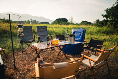 Empty chairs and tables in yard