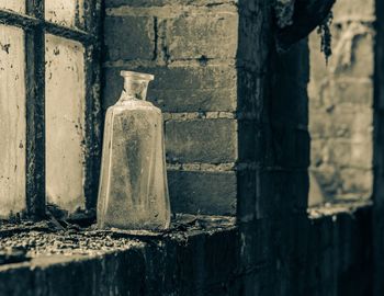 Broken bottle on window ledge in an abandoned building