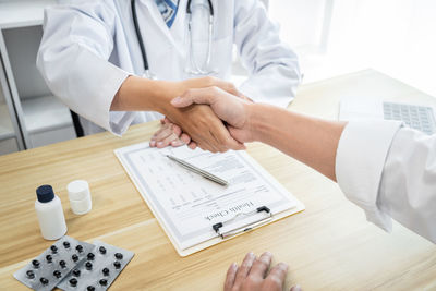 Midsection of doctor working at clinic