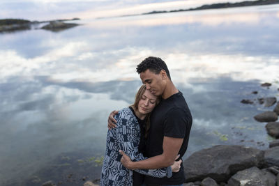 Young couple hugging at lake