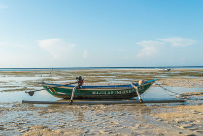 Fishing boat on beach against sky in walakiri beach, sumba