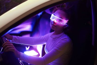 Portrait of young woman in car