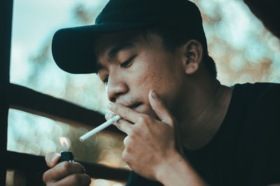 Close-up of man igniting cigarette