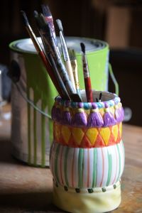 Close-up of multi colored jar on table