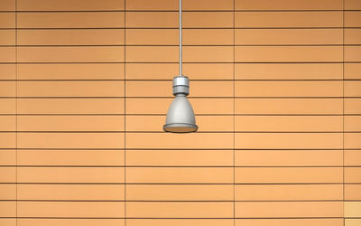 Close-up of electric lamp on wall