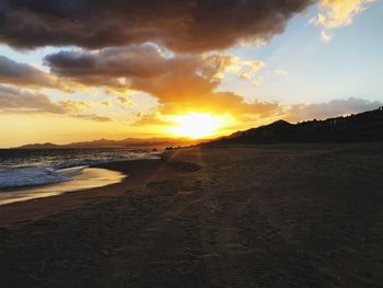 Scenic view of beach against sky during sunset