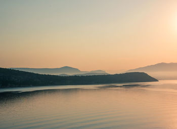 Scenic view of sea against clear sky during sunset