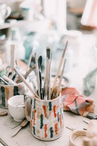 Close-up of paintbrushes in container on table